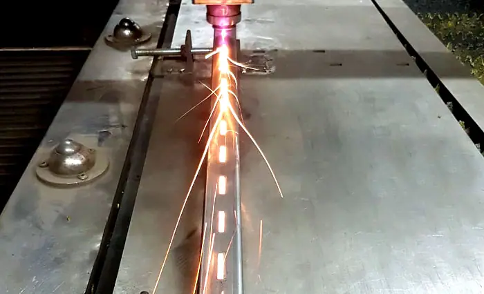 Slotted pipe being cut by laser